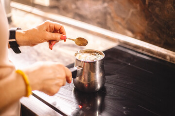 Woman brewing coffee on a stove