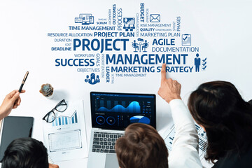 This stock photo captures a collaborative project management session, featuring a diverse group...