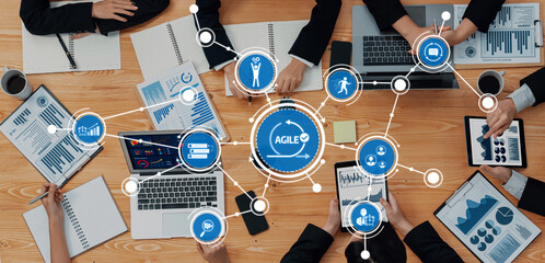 A dynamic team engages in collaborative project management using digital tools. They analyze data...