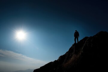 Embrace Freedom: Male Silhouette Against a Majestic Cliff at Sunset