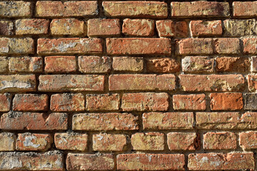Vintage brick wall texture with rough surface and natural lighting