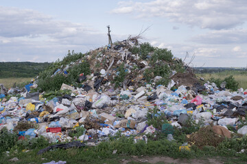 Illegal rural dump polluting a picturesque landscape with plastic waste