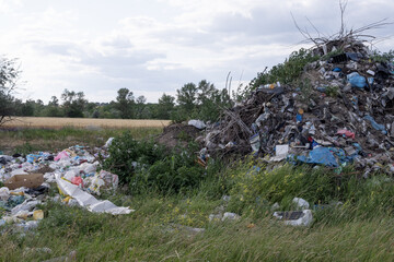 Illegal rural dump polluting a picturesque landscape with plastic waste