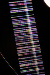 Close-up of a damaged LCD display showing horizontal and vertical pixel glitches, colorful screen...