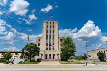 Fototapeta premium Bay County Building- Historic Art Deco Government Building in Bay City, Michigan with blue sky and clouds