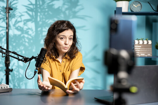 Internet show host being sponsored by partnering publisher to do new book unboxing content. Literature critic does influencer marketing, doing new author novel product placement