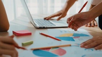 Startup company employee working together using laptop analyzing BI dashboard paper on financial data report and planning strategic marketing for creative business success in panorama video. Synergic - Powered by Adobe