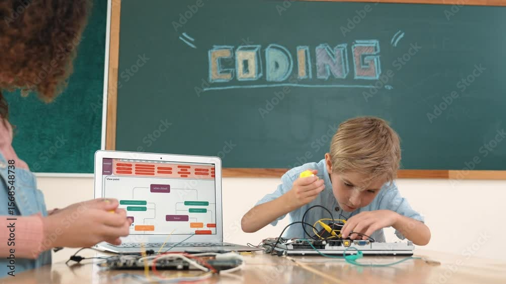 Poster caucasian smart boy fixing main board by using screwdriver at stem technology lesson while smiling s