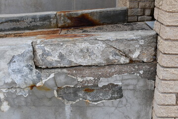 Damaged concrete on wheelchair ramp.