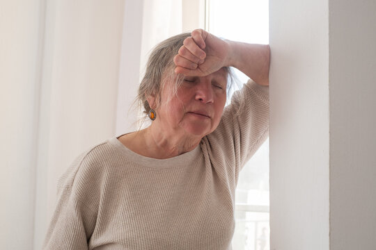 Elderly Woman Suffering from a Migraine