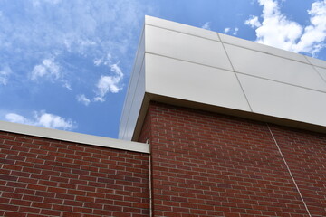 Obraz premium Large government building. Cement and brick construction. Beautiful blue sky.