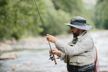 Fisherman holding fishing rod, preparing to fish in river