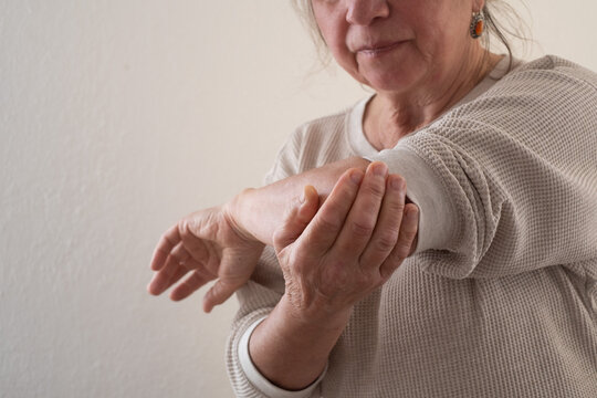 Elderly European Woman Suffering from Joint Pain, for Example in the Elbow