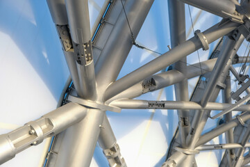 Metal framework showcasing complex engineering design under bright lighting in a contemporary construction setting