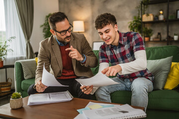 Adult professor mentor and young student hold papers and renew lesson
