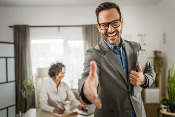 Portrait of adult caucasian man extend his hand and hold clipboard