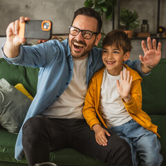 Father and son make a self portrait at living room