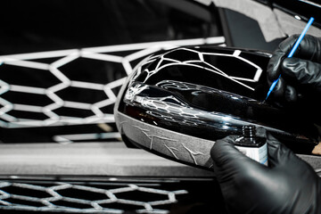 Touch-up paint applying to car chip using fine micro brush to prevent rust and restores the car...