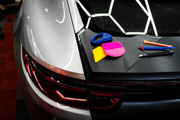 Vinyl wrapping tools and colorful applicators. Blades, scrapers, and squeegees enable smooth and...