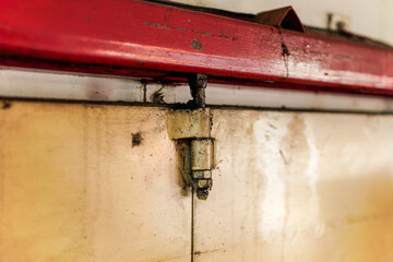 A close-up captures the essence of aged hardware, highlighting a sturdy metal hinge. The piece exudes a rustic charm, showcasing wear and accumulated residue, perfect for vintage-inspired projects.