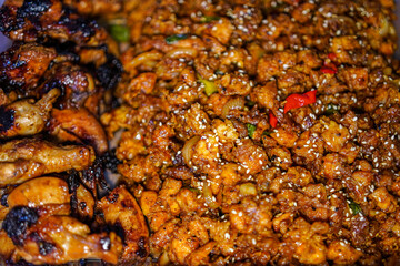 An overhead shot captures delicious sesame chicken. Glazed chicken pieces provide a tasty culinary option, seasoned to perfection and ready to eat with friends and family.