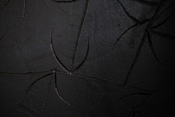 Dark Textured Art, Abstract black surface with leaf like carvings creating depth and mystery