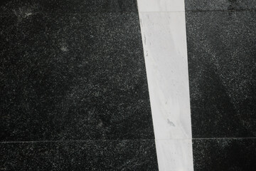 Contrasting stones create a minimalist modern floor design with bold lines and textures