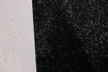 Granite contrasts, a stark white expanse meets a dark speckled section highlighting texture and...