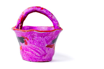 flower basket made of small clay colored with purple paint, isolated on white background