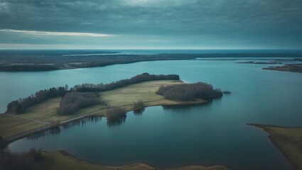 Fototapeta premium Panoramic aerial view of a lake with the sea in the background and empty space for text