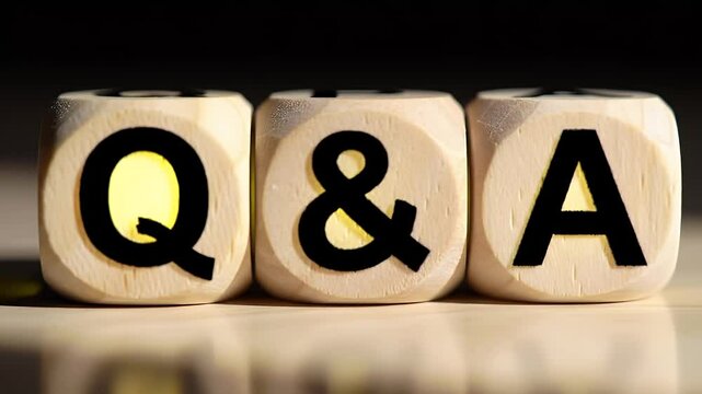 Dice Cubes Displaying Q&A on a Light Surface with Dark Background and Shadow