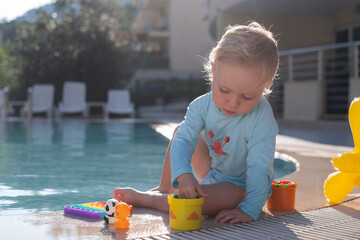 Toddler Playing in a Pool Wearing a Sun Protection Shirt