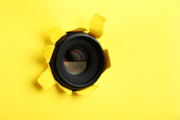 Hidden camera lens through hole in yellow paper