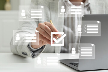 Human resources manager putting check mark on virtual screen with resumes, closeup
