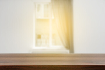 Empty wooden table against window with curtain in room