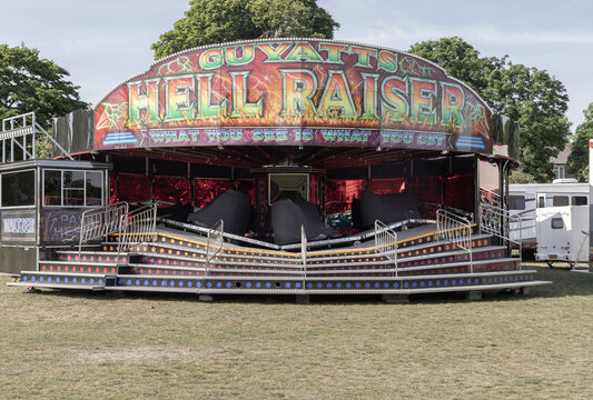 London, UK - May 14, 2025 - a "Waltzer" ride, is feature multiple cars that spin individually while the entire ride platform rotates, creating a dizzying experience for riders. is set up outdoors.