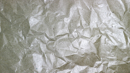 Wrinkled silver foil texture background abstract crumpled shiny paper surface