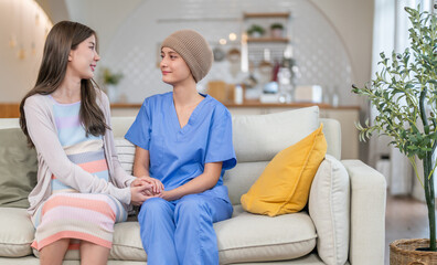 Cancer patient receiving emotional support and care from loved family during chemotherapy recovery,...