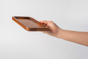 Wooden plate in hand on white background.
