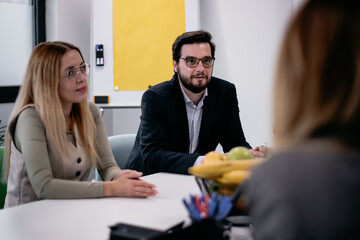 Professional meeting between coworkers at an office space focusing on discussion and teamwork.