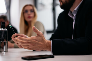 Close-up of a professional discussion with participant gestures during a meeting