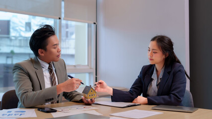 asian adult business professionals discuss real estate property investment in office meeting strategy