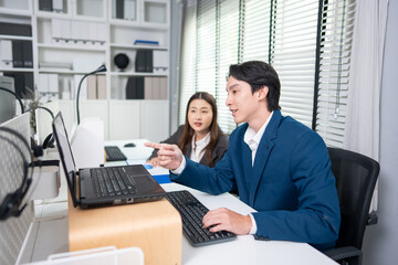 Asian young businessman and businesswoman worker working in the office.