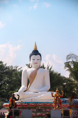 White buddha sitting image in  Latthiwan Temple (Wat Kon Tan) ,Chiang Mai of Thailand on blue sky...