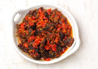 Dendeng balado is a typical West Sumatran dish made from thin and wide slices of beef which are first boiled, then dried in the sun until dry.