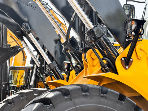 Heavy machinery working at a construction site with hydraulic systems displayed clearly during daytime