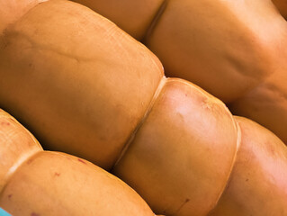 Exploring the vibrant texture and warm hues of a freshly harvested batch of ripe mangoes in a local...