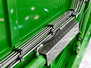 Detailing the vibrant green machinery with chrome accents and patterned surfaces, showcasing...
