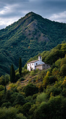 Remote historic house on a lush European hillside