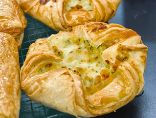 Deliciously baked savory pastries cooling on a wire rack in a cozy kitchen, inviting a taste of homemade goodness
